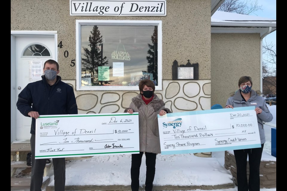 Adam Franko, CEO of Luseland Credit Union, Kathy Reschny, administrator for the Village of Denzil and Tara Gartner from Synergy CU, make apresentation to the roof replacement project in the community of Denzil.