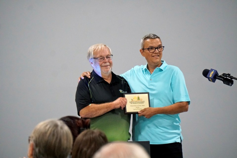 Larry Preddy, left, receives a Saskatchewan Regional Park Volunteer of the Year Award from long-term board member Greg Hoffort.                               