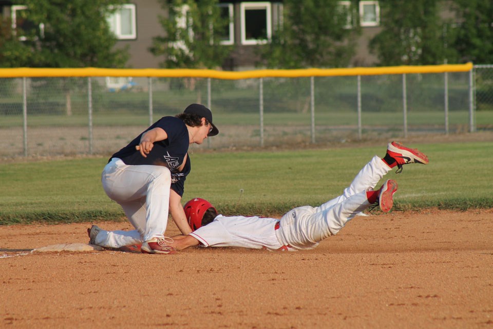Carlyle’s Brett Turgeon is tagged out by Carnduff’s Aiden Trimble at third base.
