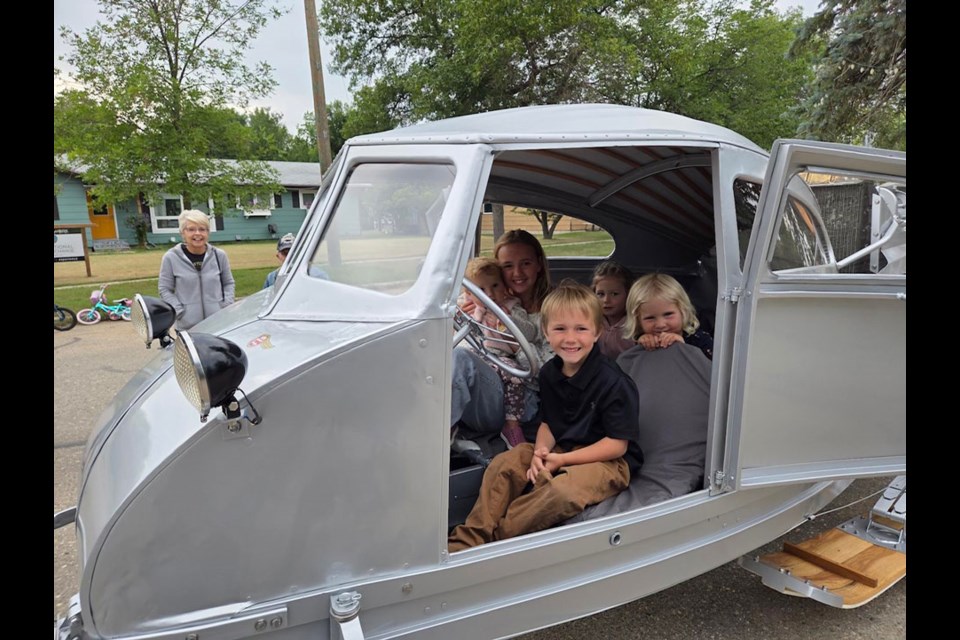 Everyone, including the Gunderman and Dunnigan grandchildren, enjoyed the hands-on experience with The Delivery Wagon. 
