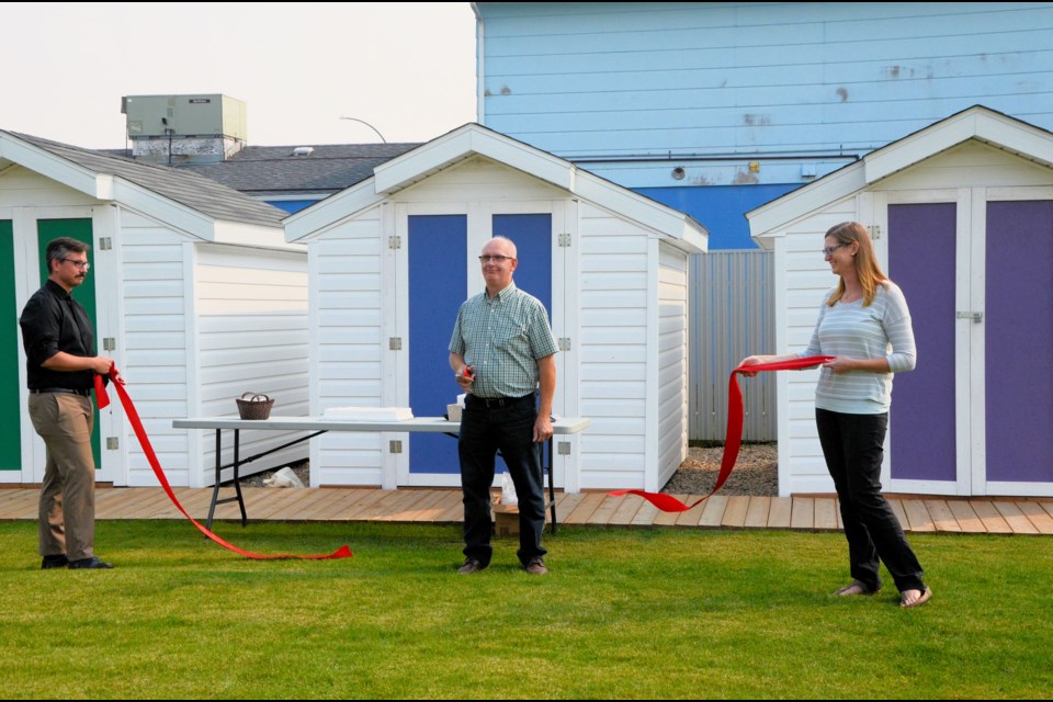 The ribbon floats to the ground, after it is cut by Wilkie Mayor David Ziegler at the grand opening of 2nd Avenue Park, Sept. 13. Holding the ends of the ribbon are Connor Piller, acting town administrator, and Lori Fenrich, parks and recreation director and economic development officer.