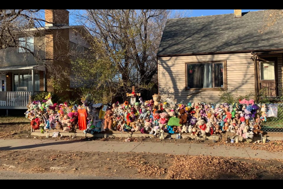 Flowers, stuffed toys and other items are put in place near the site where a nine-year-old girl was hit by a vehicle in September last year.