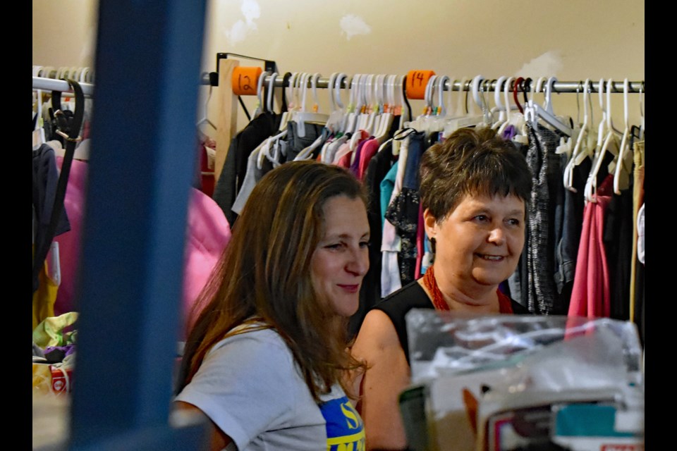 Baba's Closet coordinator Nettie Cherniatenski, right, enjoys a light moment with Deputy Prime Minister Chrystia Freeland during her visit at the donation facility late Wednesday afternoon, Aug. 24.