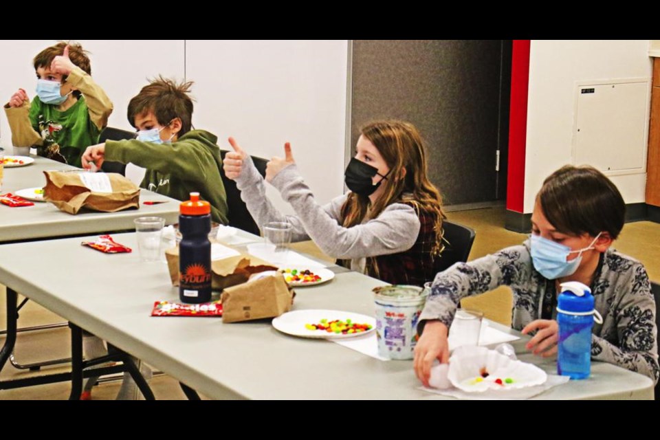 Participants in the Candy Chemistry class gave a thumbs-up to the virtual leader as they did one of the steps in an experiment on Saturday.