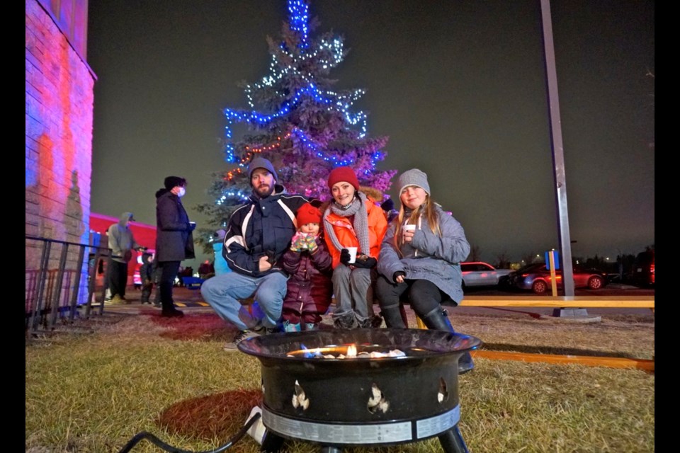 Chris, Briar-Rose, Emily and Aaliyah McLennan took a moment to warm up by the fire listening to Christmas tunes.                               