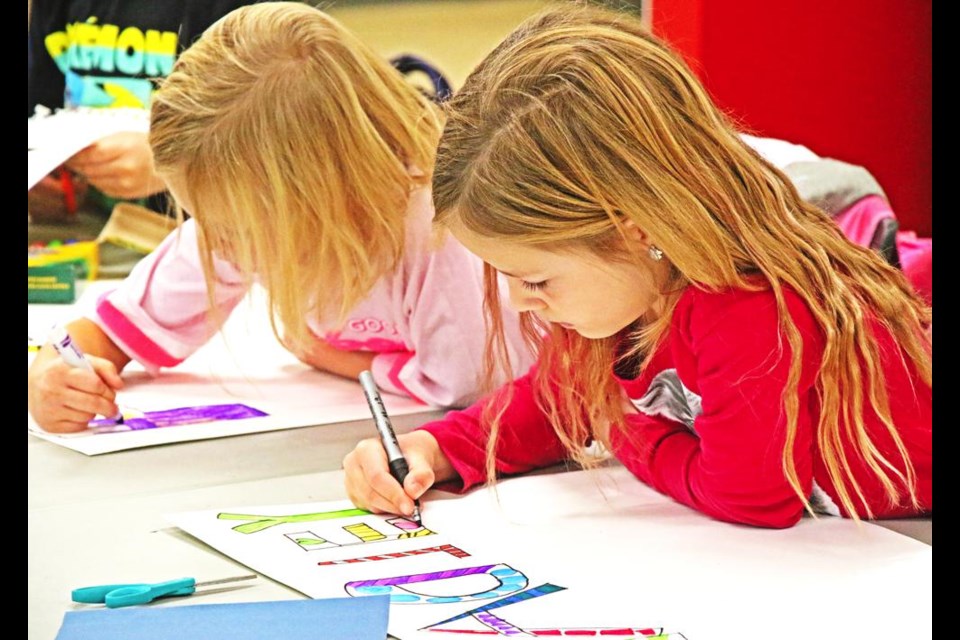 Fiona and Hadley worked side by side on decorating their names as one of the art activities on Friday.