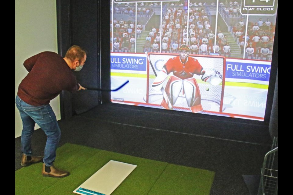 Leisure services manager Ryan Dale shot into the corner of the net and scored in the hockey game simulation.