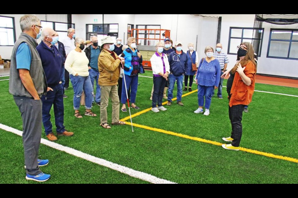 Regan Lanning talks to members of the Weyburn Rotary Club about the indoor sports field at the Spark Centre, with the same artificial turf as used at Mosaic Stadium.