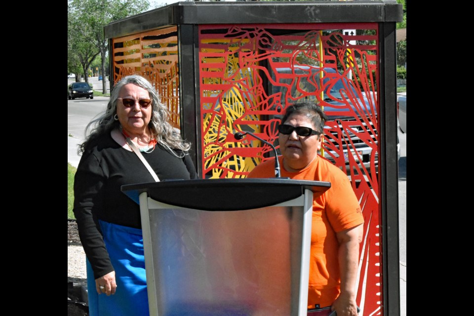 Laureen Paul, left, and Pauline Okemow share their experience in helping make the art project a reality. 
