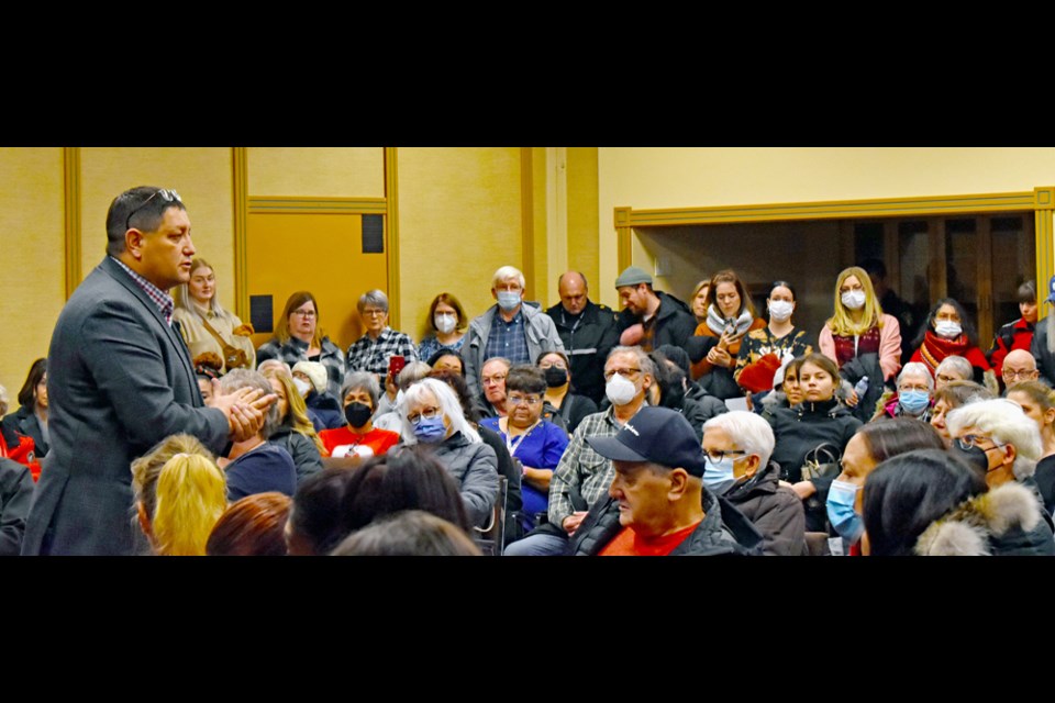 Saskatoon Tribal Council Chief Mark Arcand, left, speaks to residents of the Fairhaven community and their other partners in a recent open house of the new Emergency Wellness Centre.