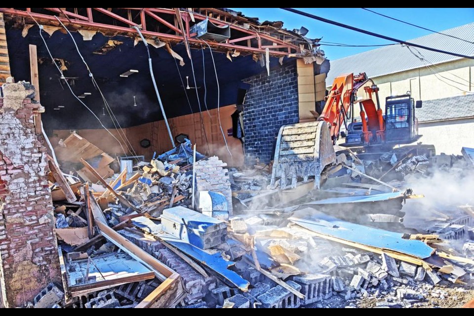 Dust flew up as the back wall collapsed over late Tuesday afternoon, during the demolition of the Soo Theatre.