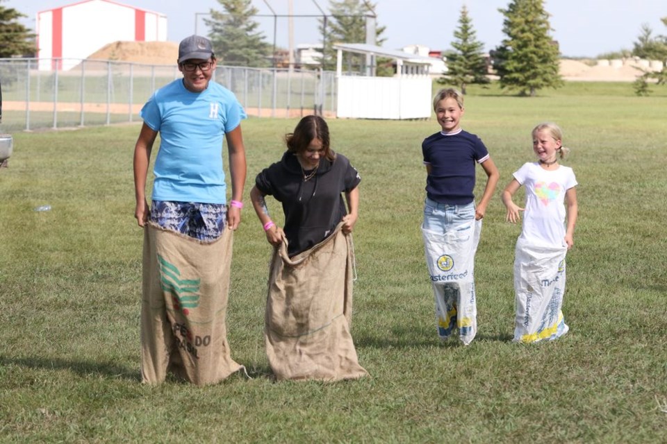 Between the chariot races and gymkhana on Aug. 20, children competed in a sack race. From left are Dominick O’Soup, Ocean Hitchens, Lexus Hitchens and Tyler Griffith.