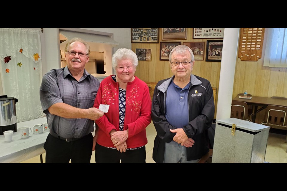 The happy winner of the Canora Ss.Peter & Paul Ukrainian Catholic Parish 50/50 draw was Poly Ripa. From left, were: Harold Woloschuk holding the winning ticket stub, Ripa, and Allan Wonsiak, keeper of the tickets.
