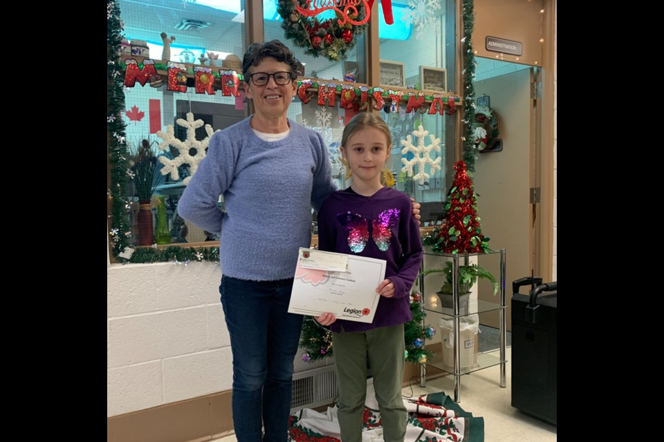 Students at Canora Junior Elementary School were successful in the Remembrance Day contest held by the Canora branch of the Royal Canadian Legion. Lorri Dennis, Legion representative, presented the $100 first prize to Aliannah Herriges in the primary coloured poster division.