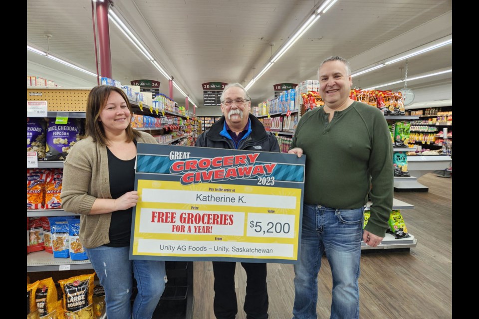 Katherine King was all smiles when she was presented $5,200 from Unity AG Foods after learning she won "free groceries for a year" through a contest at the location.