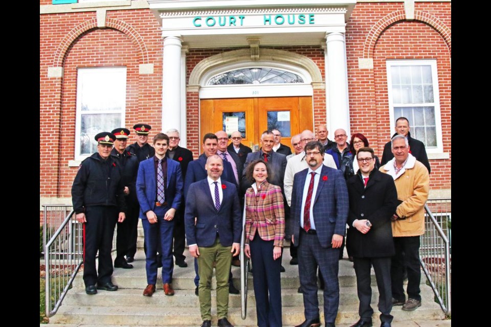 Weyburn-Big Muddy MLA Dustin Duncan and Justice Minister Bronwyn Eyre, front centre, were joined by the guests on hand for her announcement about reopening Court of King's Bench Judicial Centre and registry office, on the front steps of Weyburn's historic court house on Thursday afternoon.