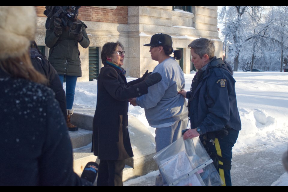 Senator Kim Pate greets Nerissa Quewezance as she's escorted into Court of King's Bench on Jan. 18.