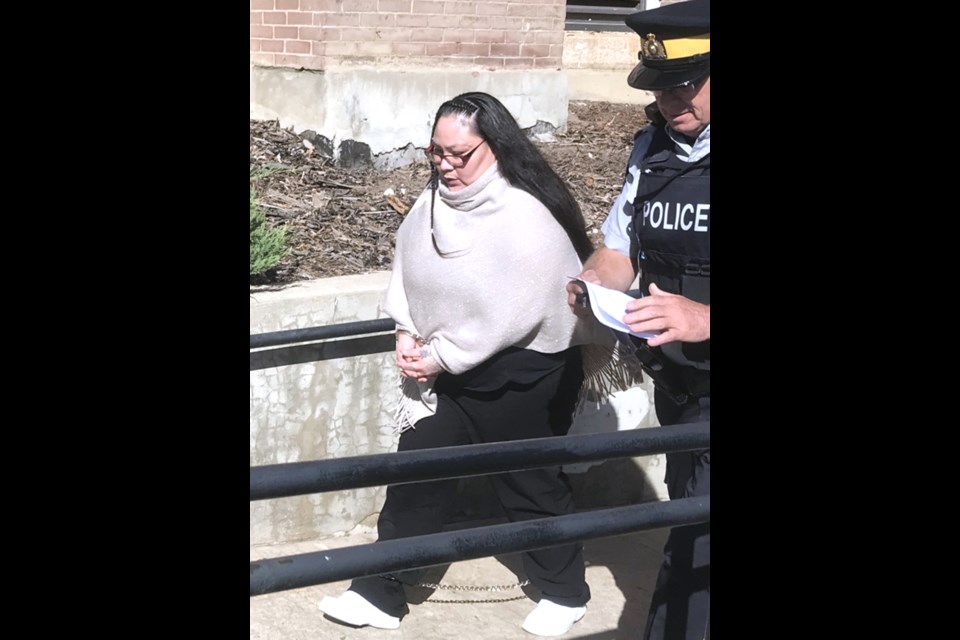 Soaring Eagle Whitstone is escorted out of the Battleford Court of King's Bench in September 2022 after the first day of her first-degree murder trial.