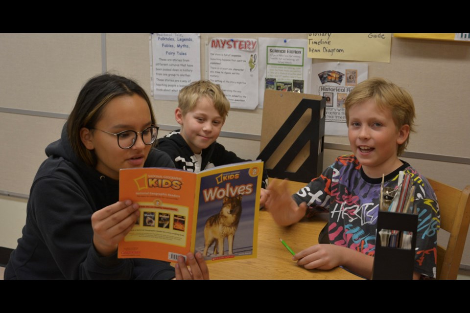 On Oct. 21, Buddy Reading once again took place during Education Week, as students from Canora Composite School read to their younger buddies from Canora Junior Elementary School. From left, Savannah Bryant read to Taylor Effa and Skylar Brass from a book of their choice.