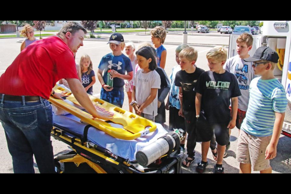 Paramedic Daniel Kelly showed the gurney and backboard used for patients who need an ambulance.