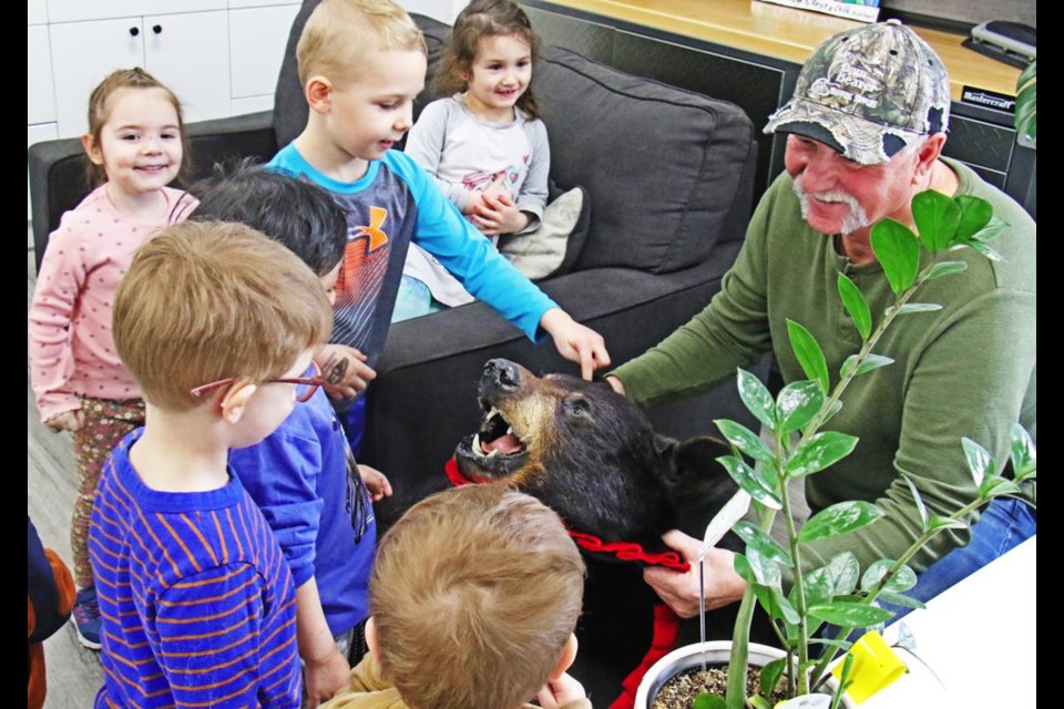 Dale Paslawski of the Weyburn Wildlife Federation smiled as a boy poked the head of a bear skin, during a presentation at the Family Place on March 5.