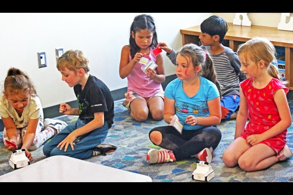 Grade 1 students listened for instructions for activating 'Codey', during a visit by an EYES team on Tuesday at Legacy Park.