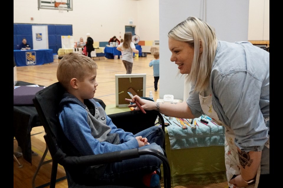  Alyssa Harrison helped Koa Wanner turn into Spider-Man during the Family Resource Expo.                             