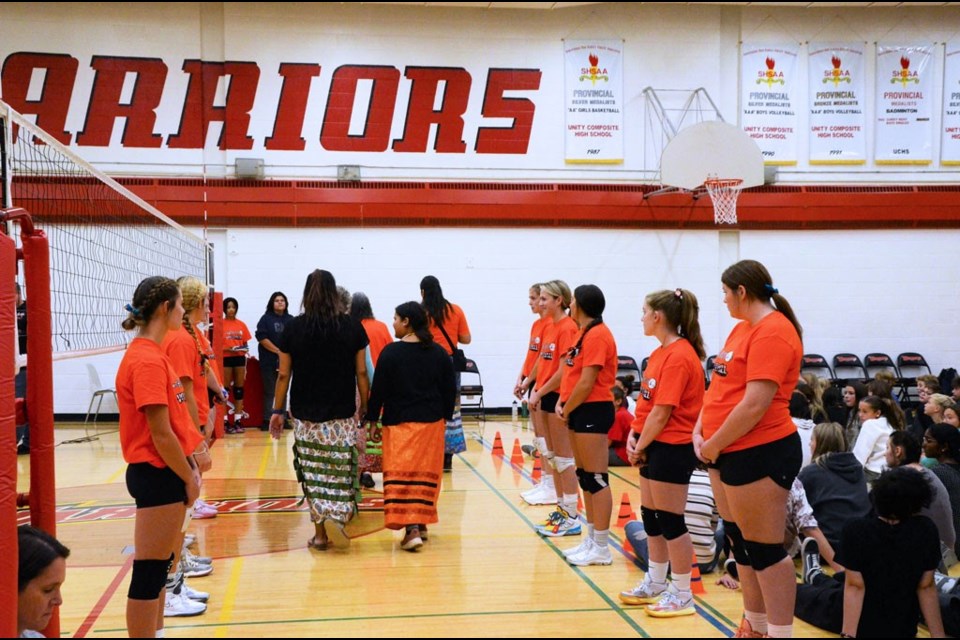 Members of the senior girls’ volleyball team form an honour guard for the special guests at the UCHS flag raising.