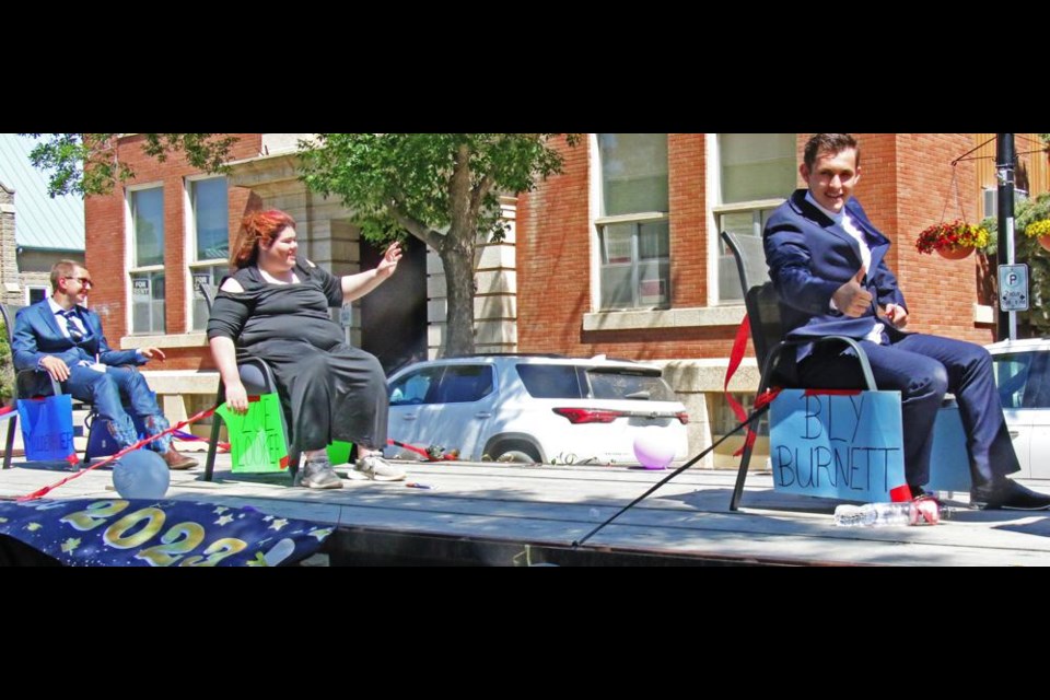 Grads Ty Moldenhauer, Zoe Looker and Bly Burnett rode on their own float in the grad parade on Saturday.