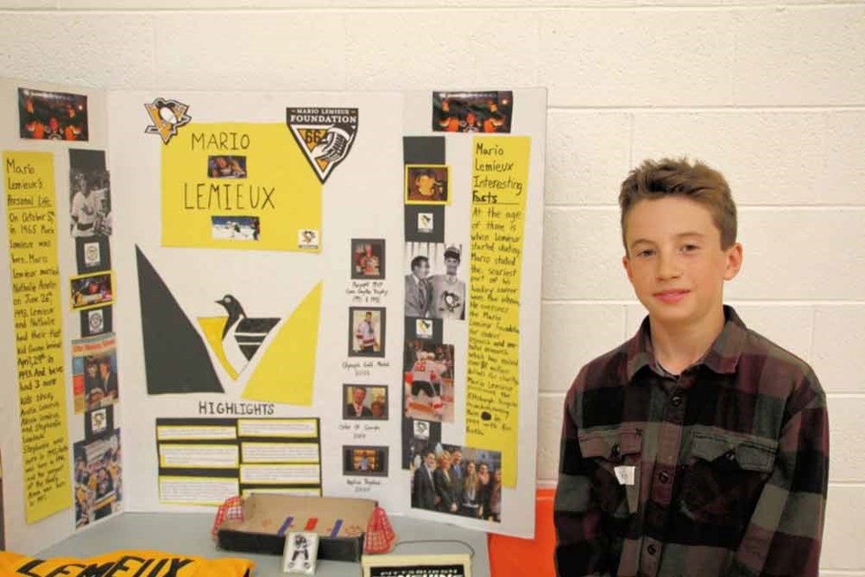 Kellen Headrick beside his winning Heritage Fair project on Mario Lemieux. 