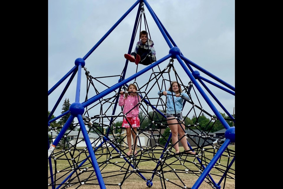 These three kids were up on the net climber at Hillcrest School’s playground every morning ever since the construction was installed. 