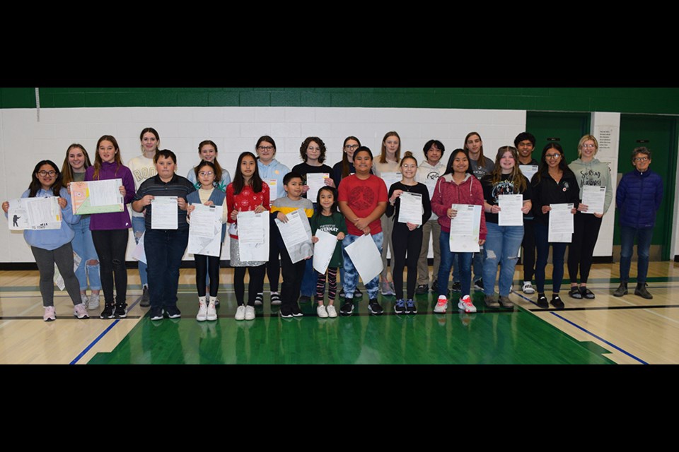 Invermay School winners in the Legion Remembrance Day district contest, from left, were: (back row) Tyla Dubas, April Grychowski, Addison Enge, Cassidy Bosovich, Madeline Glas, Jasmin Kowalyshyn, Elissa Karcha, Angelo Ferenal, Remy Fidek, Aron Cudal, Rachel Enge and Canora Legion Member Lori Dennis; and (front) Cassandra Ponte, Paisley Bosovich, Kristian Oie, Jessica Ke, Thea Barcelona, Juan Migel Lucas, Hailee Ferenal, Perseus Mesias, Brielle Enge, Cielo Marasigan, Marissa Fidek and Gwyn Cabungcal. Unavailable for the photo was Halo Engele.