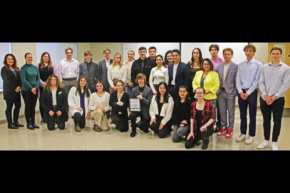 The Entrepreneurship 30 students who formed and ran the Cloud 9 Clothing Company gathered on Thursday for their final board meeting of the semester. In the back row from left are business mentors Andria Brady, executive director of Community Futures Sunrise, and Monice Osborn, manager of the Weyburn Chamber of Commerce; Lee-Ann Harkes, Axton Dionne, Liam Evans, George Hoffman, Katelyn Thackeray, Maddie Gerry, Dalton Molnar, Kaleb Charlton, Zoe Looker, Navya Arora, Cedrick Perez, Allie Cugnet, Jaxon Cook, Ryder Knox, Carter Houghton, Jake Dammann, and business education teacher Margot Arnold. In the front row are Abby Manz, Maddie Sheasby, Jordan Lindenbach, Piper McKinney, Owen Burdan, Danica Rodenbush, Ainsley Wanner and Madison Young. Missing was mentor Jeff Chessall of Weyburn Rona/New Age.