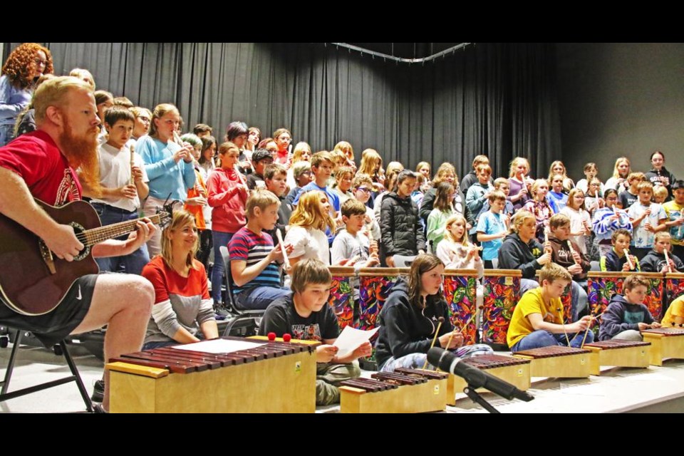 The Grade 6 choir performed with recorders and xylophones, plus v-p Tyson O'Dell on guitar at left, as they performed two songs they will be doing at Communithon on Oct. 28.