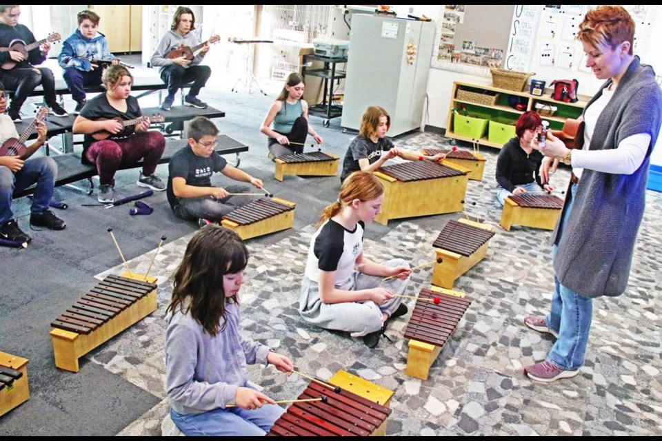 Music teacher Holly Butz, at right, led a Grade 6 class in learning a song on ukulele and xylophone, which they will perform in March at the Weyburn Rotary Music Festival.