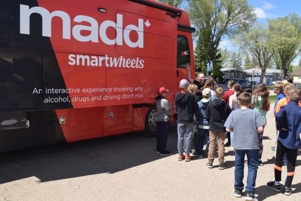 Caitlyn Hawrysh Haier (facing camera) of MADD Canada brought the MADD SmartWheels bus to Canora Composite School on June 2, and explained the dangers of impaired driving to a group of students in grades 5 to 7.