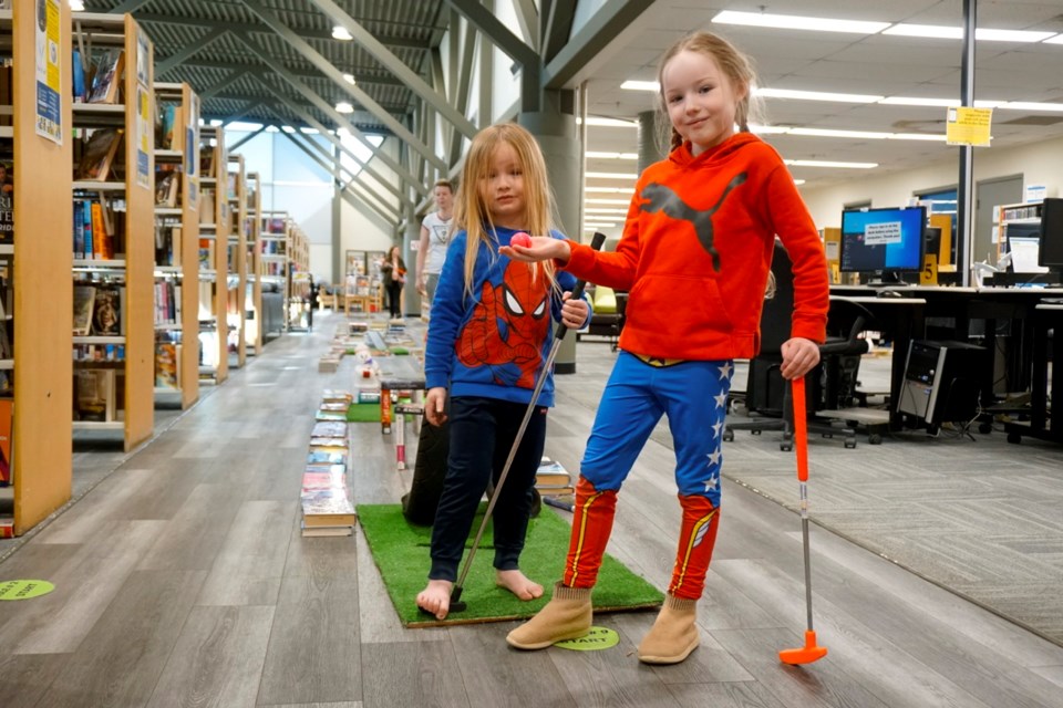 Vallyn and Thoren Hagel enjoyed a round of mini golf at the Estevan Public Library on Saturday. Vallyn won the game and said she wanted to go again. 