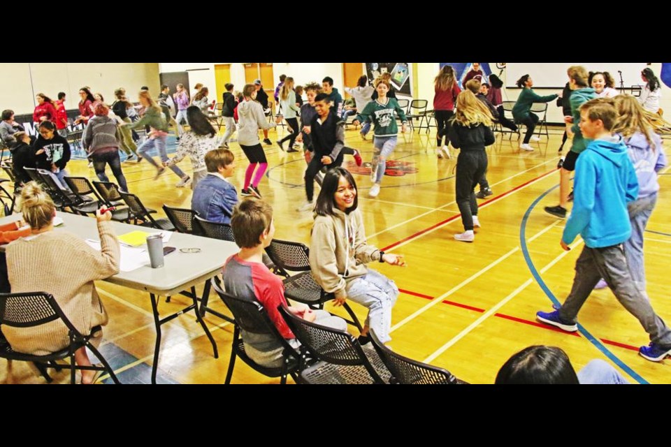 Grades 8-9 students played a form of musical chairs, using the statement, "you should move if ...", as part of the day-long retreat led by NET Ministries.