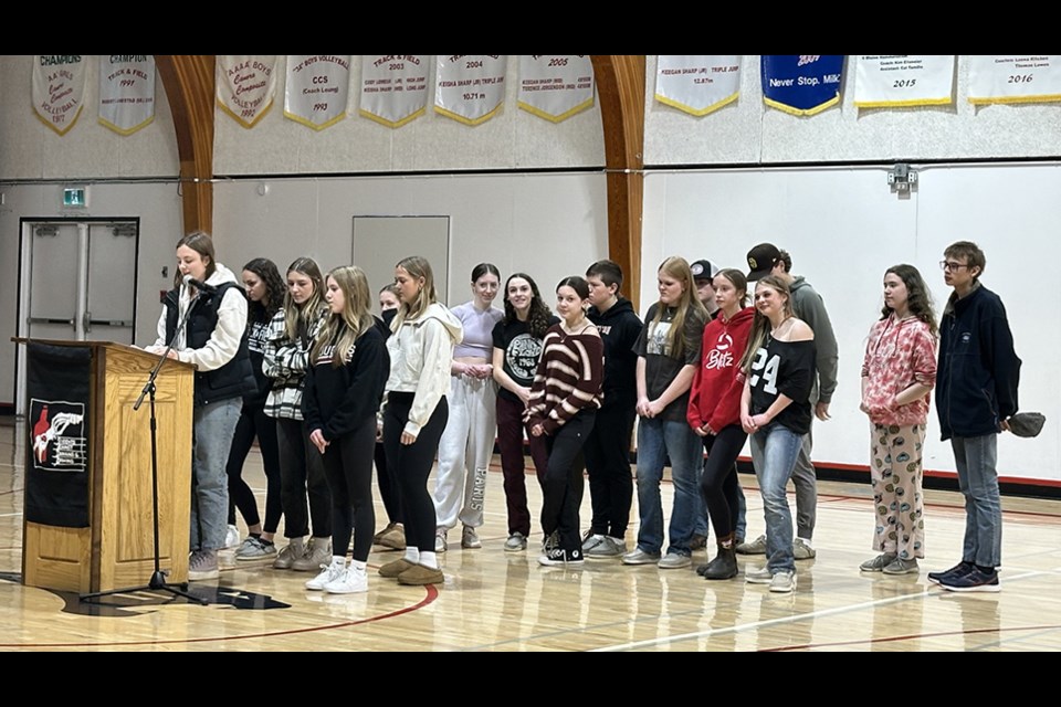Miah Ruf (at the mic) and Jada Nordin, co-chairs, were flanked by other members of the CCS SADD Chapter during Saskatchewan Impaired Driving Awareness week.