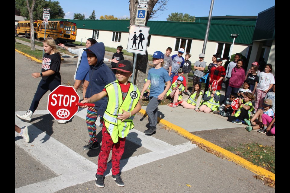 Lincoln L. (at front) makes sure a group of pedestrians cross safely at St. Michael School. 
