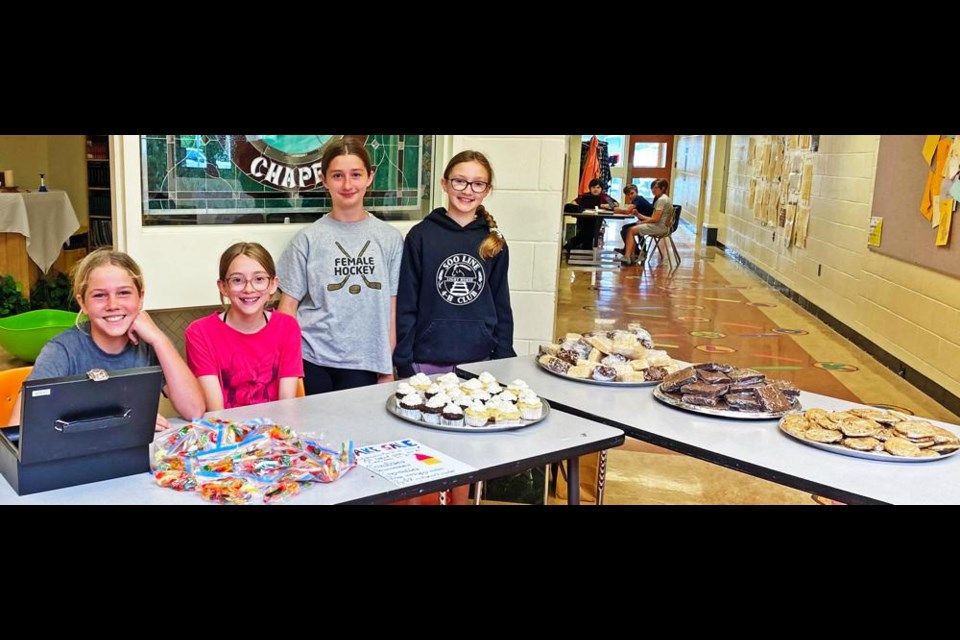 A group of Grade 6 girls, Ella Walkeden, Reese Hansen, Olivia Edwards, and Emma Winter, set up a cake sale to raise funds for the Weyburn Humane Society at St. Michael School recently.