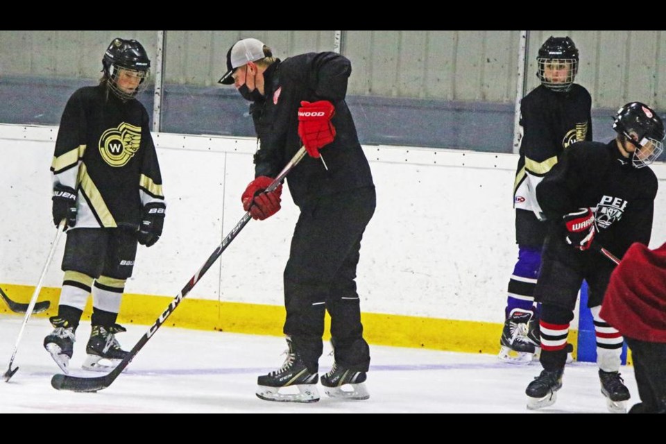 Instructor Cody Mapes showed students what he wanted them to do in a drill, during on-ice time for the Skills Academy at the Sports Arena on Thursday afternoon.