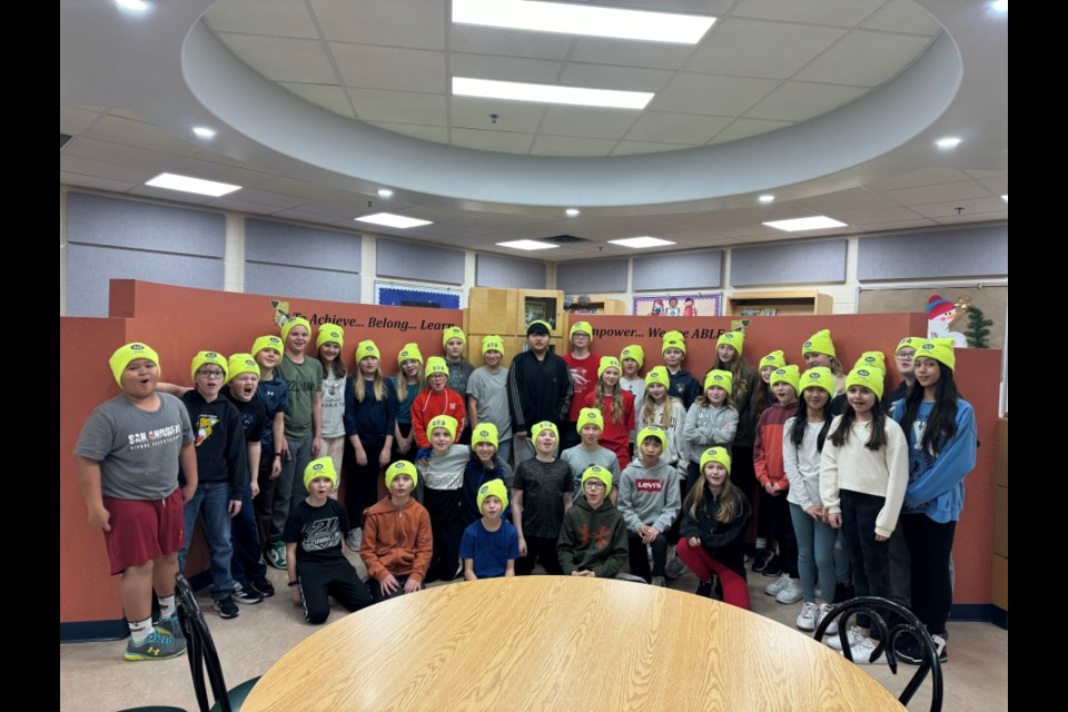 Safety patrollers from Spruce Ridge School model their toques donated by UMWA. 