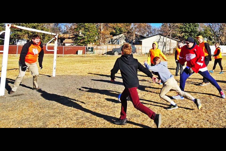 Principal Dean Loberg guarded the net as students Ethan T. and Evrhet S. bring the attack, and staff Tessa Scrupps, Chad Klein, Michael Manko-Bauche run in to help out, during a Grade 6 vs staff soccer game on Thursday at St. Michael School.