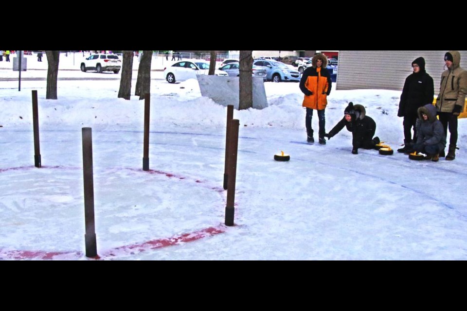 Grade 9 teacher Jodi Johnson threw out a rock to demonstrate how to play Crokicurl on Friday for St. Michael students.