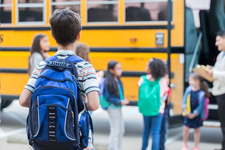 students backpack school bus