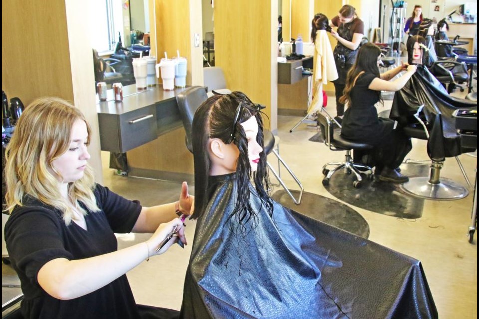 The competitors in the stylist competition concentrated on their styles on Friday.