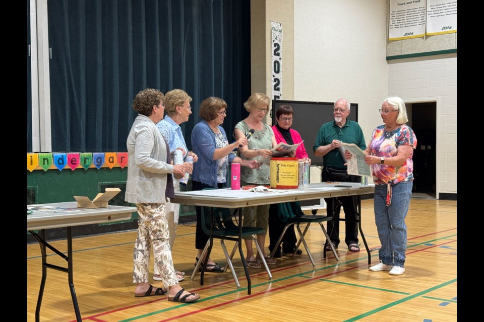 These teachers from the past were excited about opening the time capsules. 