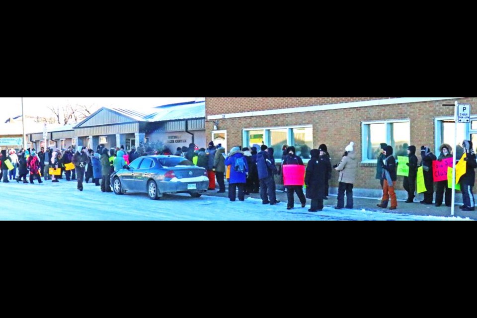 The crowd of teachers extended for at least half a block as they marched to MLA Dustin Duncan's office on Tuesday, in support of the one-day teachers' strike across Saskatchewan.