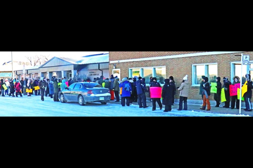 The crowd of teachers extended for at least half a block as they marched to MLA Dustin Duncan's office on Tuesday, in support of the one-day teachers' strike across Saskatchewan.